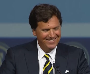 Tucker Carlson giving speech