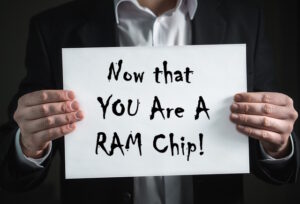 man holding sign saying you are now a ram chip