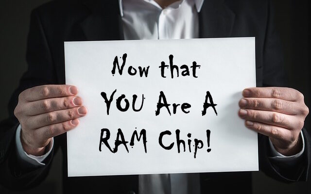 man holding sign saying you are now a ram chip